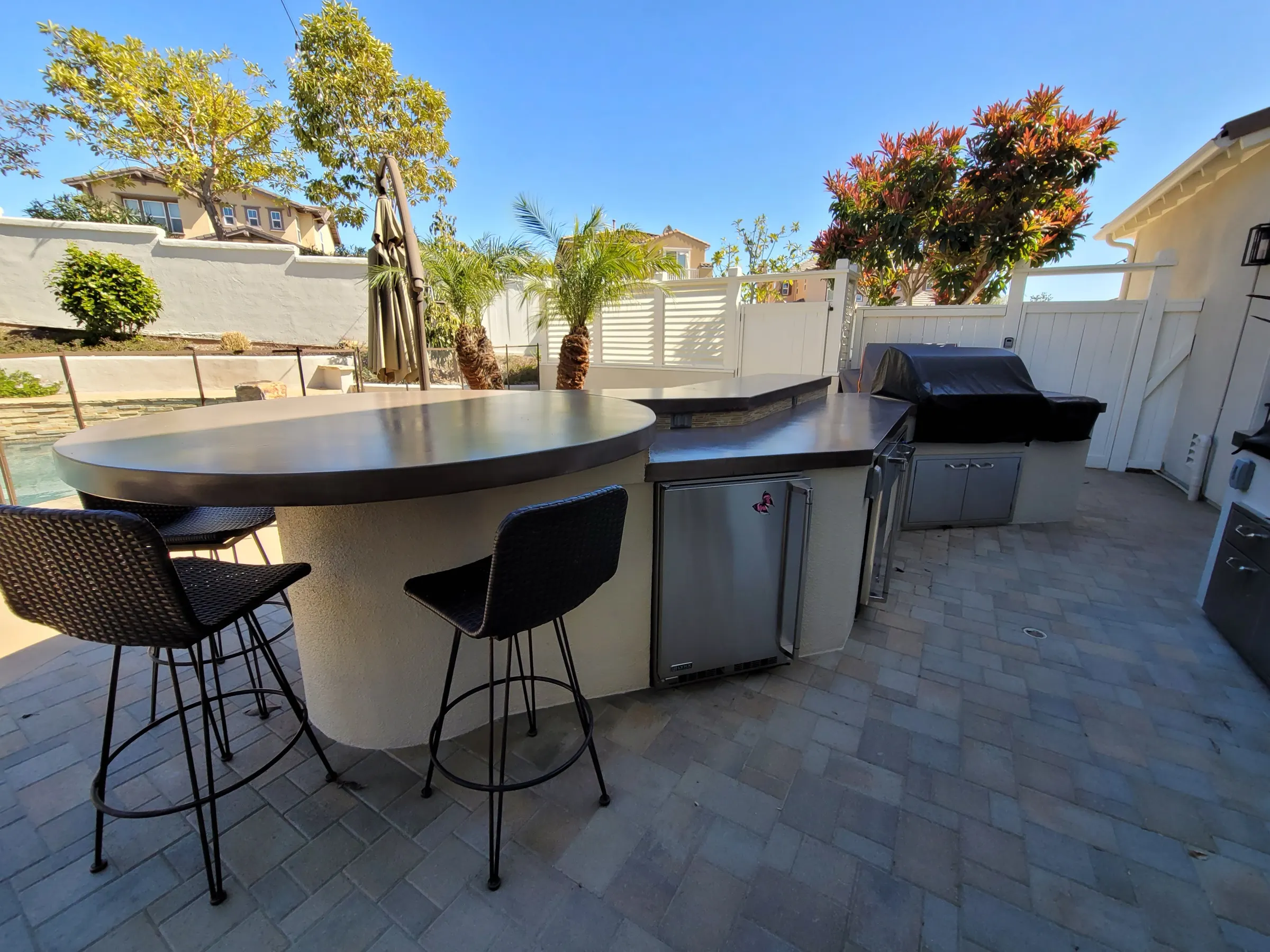 Paver patio connected to a landscaped yard